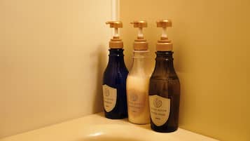 Three bottles of Estee Royale body care products on a bathroom counter.