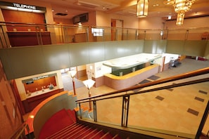 A hotel lobby with a reception desk, a staircase, and a second-floor balcony. - Trip7 Yuzawa Sky Onsen Hotel (Yuzawa)
