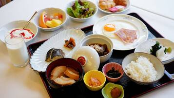 A tray with various dishes including rice, eggs, and a bowl of soup.