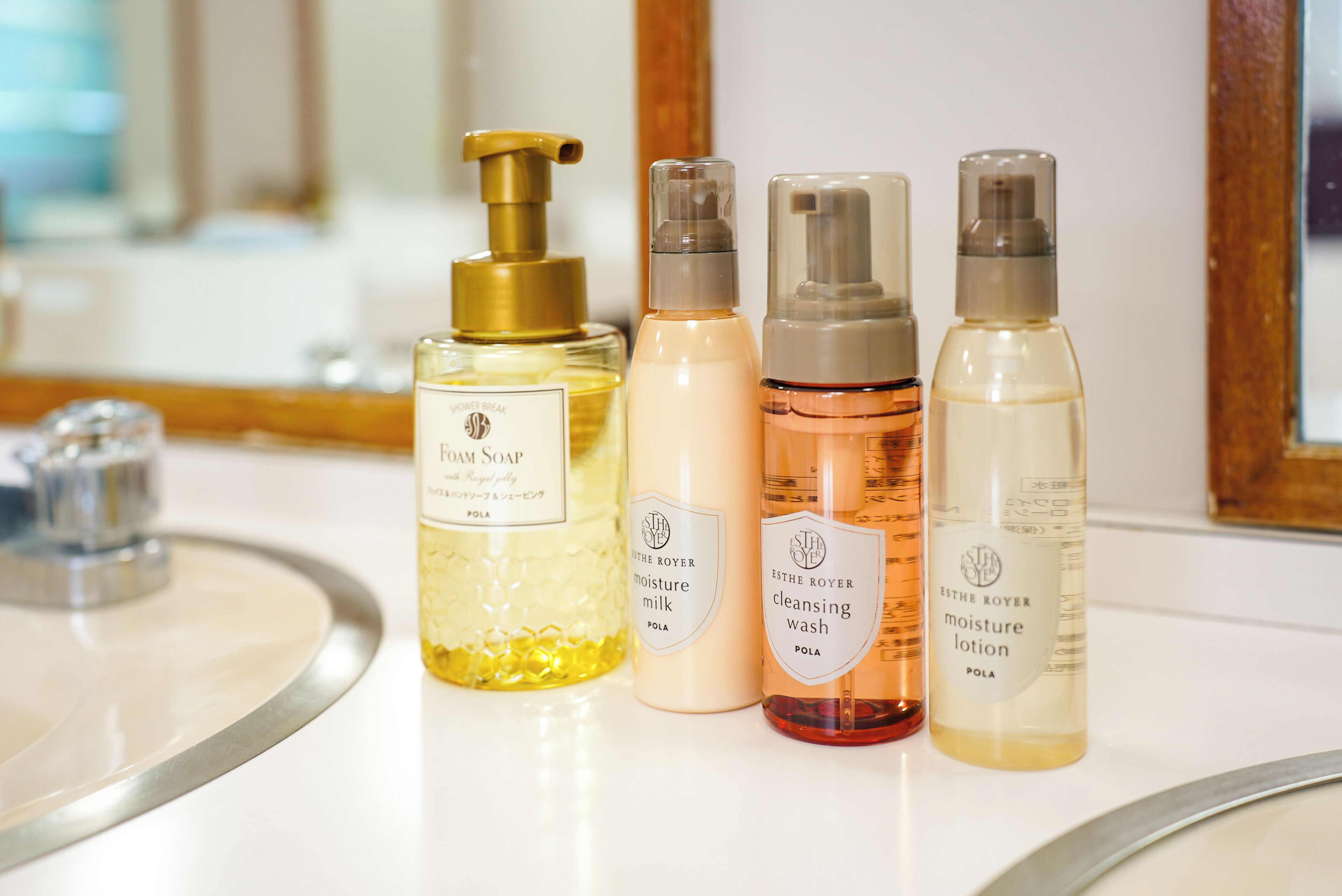 A row of toiletries on a bathroom counter.