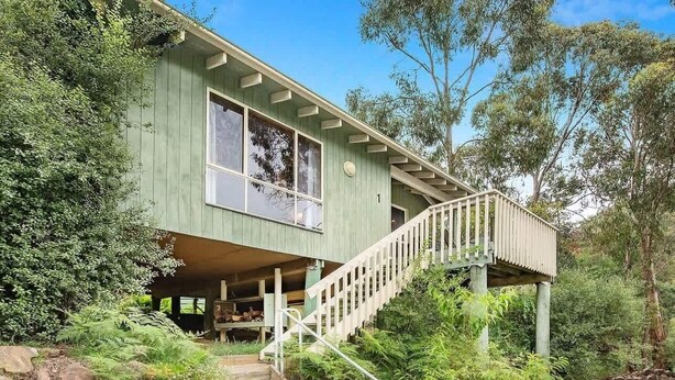 A two-story house with a staircase leading to the upper floor. - Canobolas Mountain Two-Bedroom Cabin 1 (Canobolas)