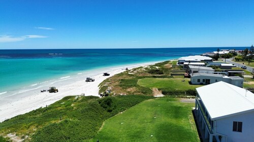 Oceanfront retreat with breathtaking views steps from the shore.
