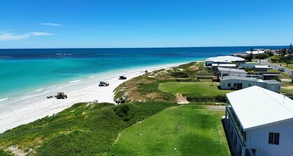Oceanfront retreat with breathtaking views steps from the shore.