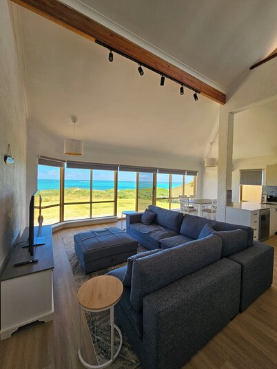 Oceanfront retreat with breathtaking views steps from the shore.