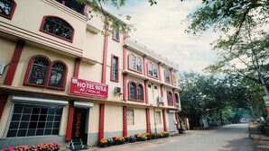 A two-story building with a sign reading "HOTEL NISA AC/Non AC." - Hotel Nisa (Bolpur)