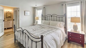 A bedroom with a bed, bedside tables, a ceiling fan, and a window with curtains. - Scenic Sandia Mtn Views! Cozy Rio Rancho Retreat (Rio Rancho)