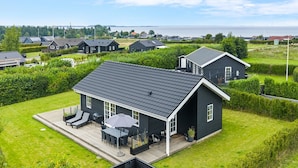 A modern house with a large deck, surrounded by well-maintained lawns and hedges. - "Rixa" - 350m from the sea by Interhome (Frørup)