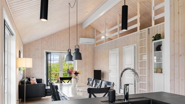 A modern kitchen with a central island, black pendant lights, and a built-in sink. - "Rixa" - 350m from the sea by Interhome (Frørup)