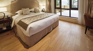 A neatly made bed with a headboard, a bedside table with a lamp, and a view of the outdoors through a window. - Hangzhou Leisure Lake The Dragon (Hangzhou)