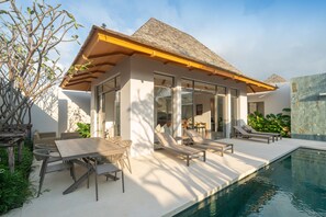 A modern house with a swimming pool, outdoor seating, and a covered patio. - Tropical Pool Anchan Indigo 16 (Thep Krasattri)