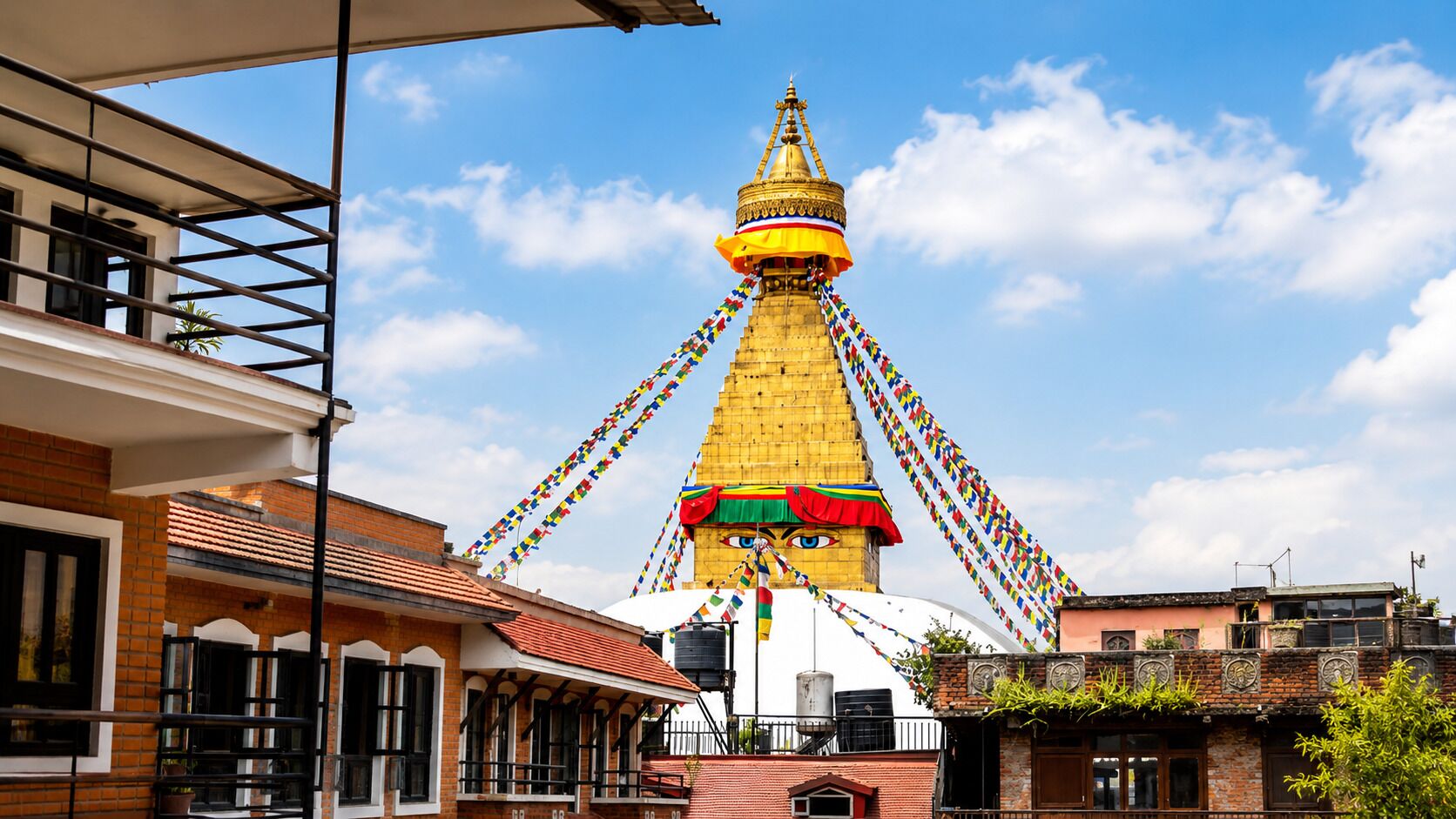 A traditional building with a prominent golden stupa, a brick facade, and a clear blue sky.