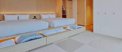A modern hotel room with a large bed, built-in storage, and a visible air conditioning unit.