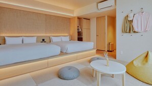 A modern hotel room with a large bed, a small table, and a seating area. - FAV LUX MIYAZAKI (Miyazaki)