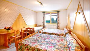 A bedroom with two beds, a wooden desk, a chair, and a window with curtains. - Bed and Breakfast 'Chambre Jaune' with Shared Terrace, Shared Garden and Wi-Fi (VERRIERES)