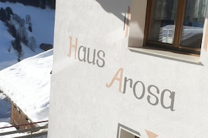 A building with the text 'Haus Arosa' on its exterior wall.