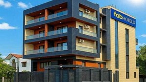 A modern multi-story building with a flat roof, a flat facade, and a sign indicating it is a hotel. - Hotel Vibe BLU (Noida)