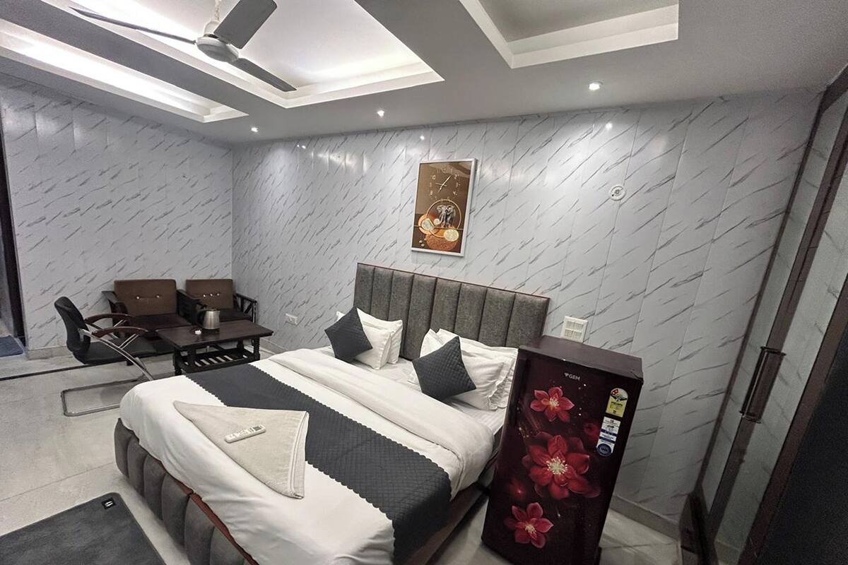 A modern bedroom with a bed, a desk, and a chair.