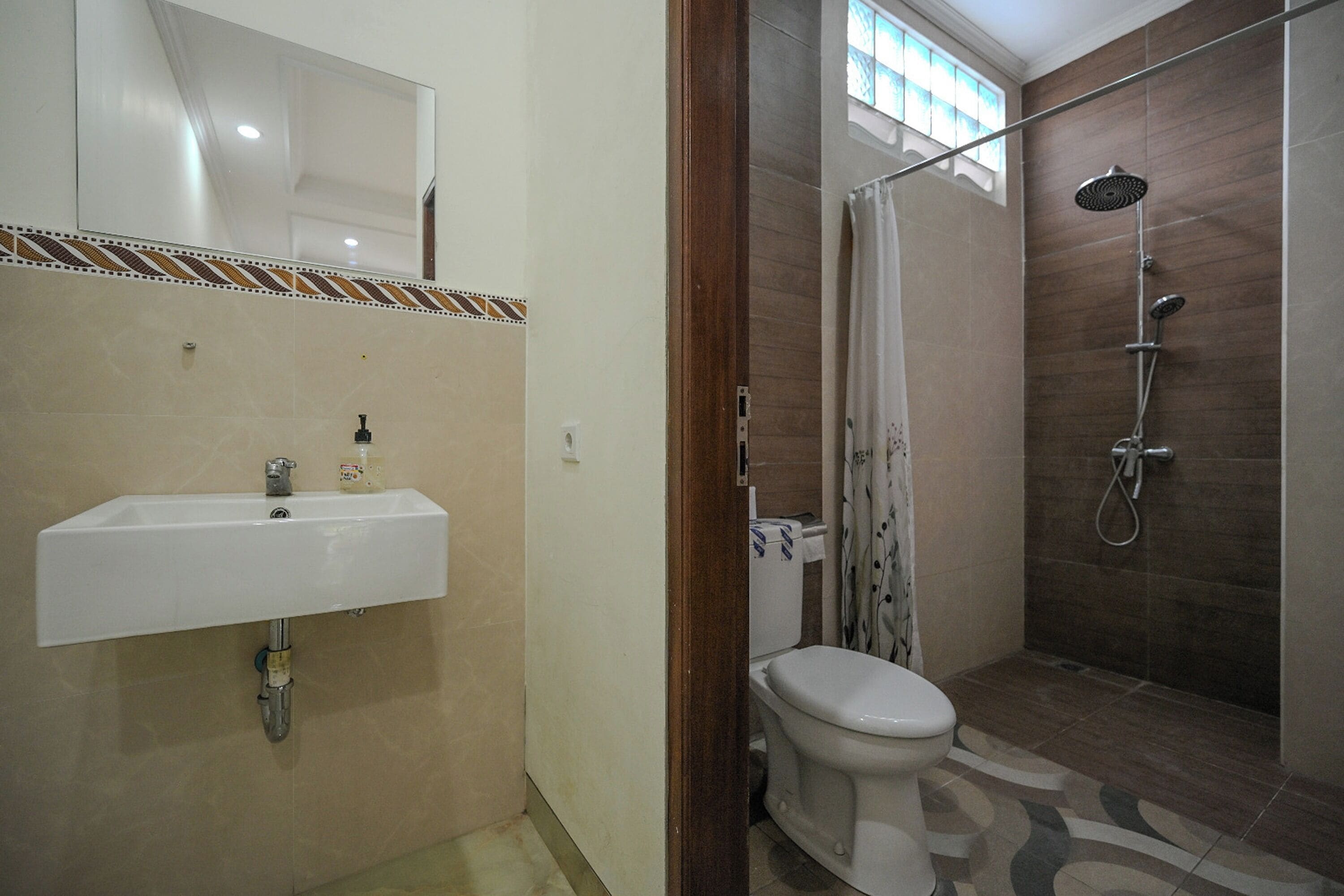 A bathroom with a sink, toilet, and shower.