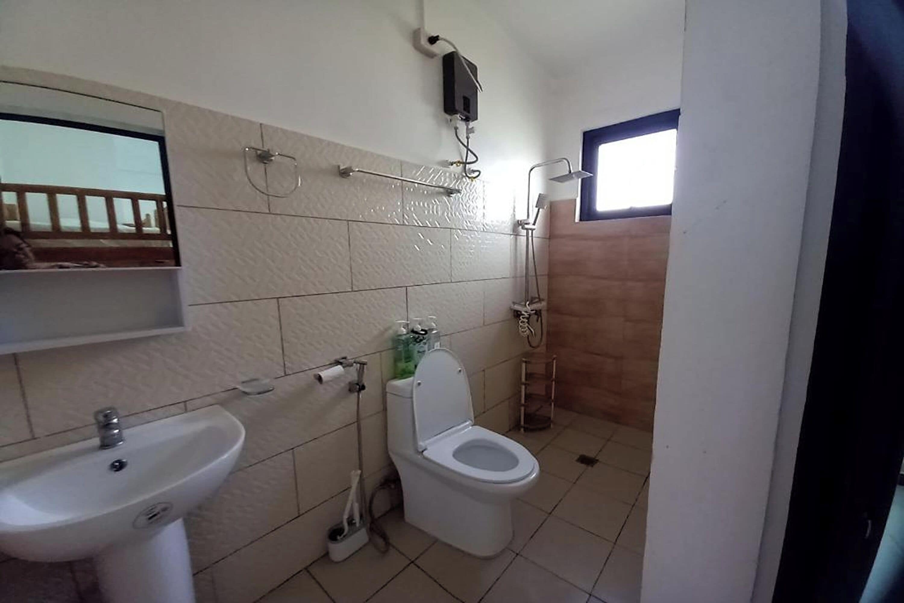 A bathroom with a sink, toilet, and shower.