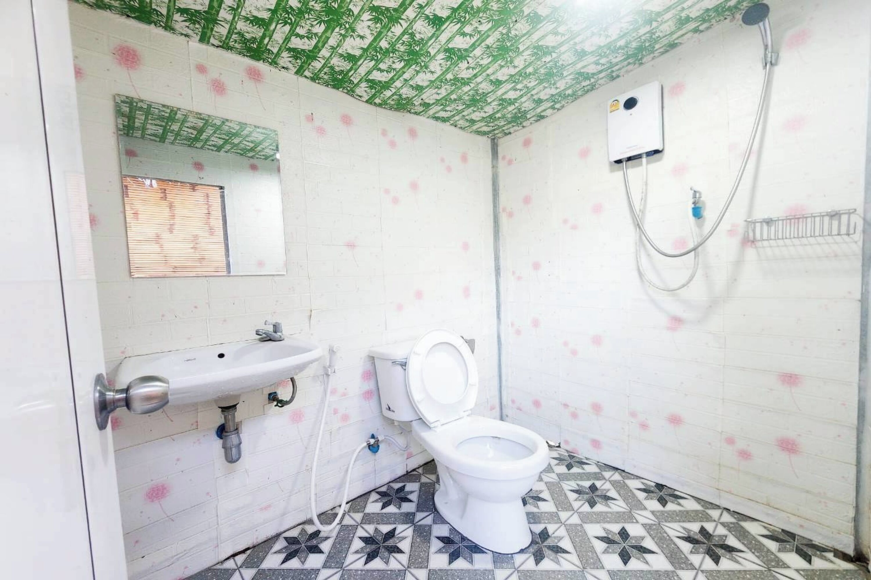 A bathroom with a toilet, sink, and shower.