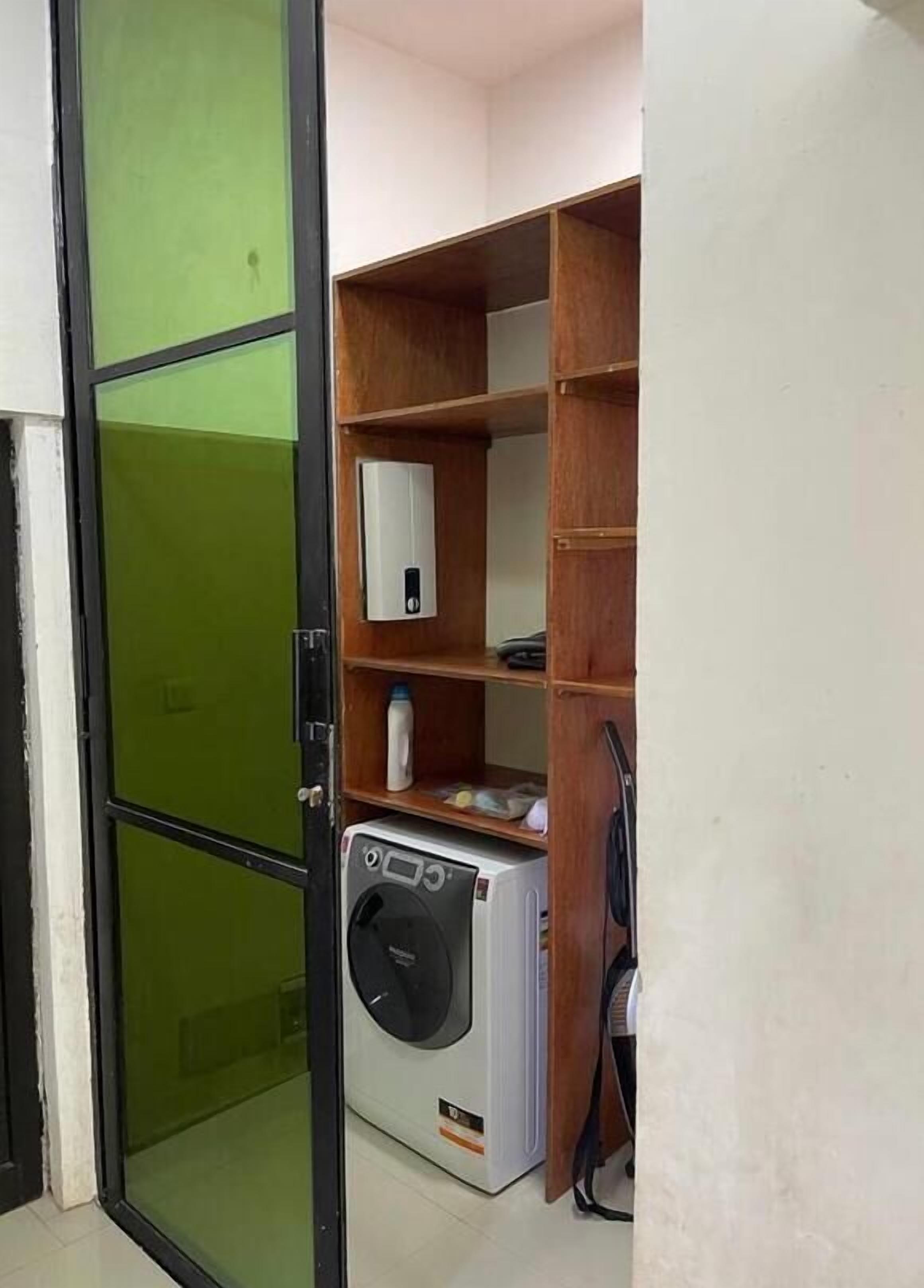 A laundry room with a washing machine, a dryer, and a water heater.