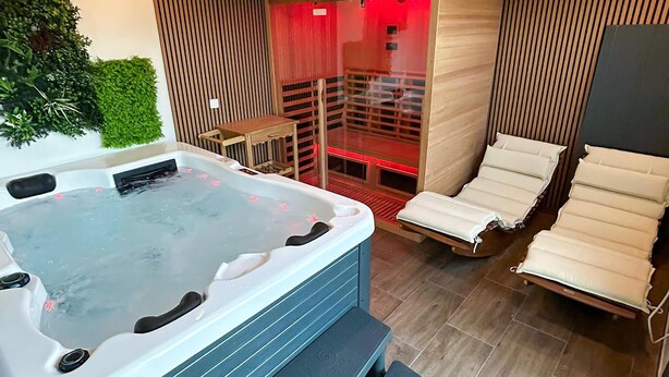 A hot tub with a wooden deck and lounge chairs. - Gorgeous home in Slavonski Brod with sauna (Slavonski Brod)