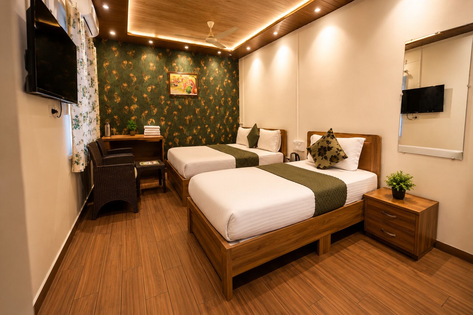 A hotel room with two beds, a desk, a chair, a TV, and a mirror.