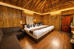 A room with a bed, a sofa, and a wooden ceiling. - Hotel Happy Forest Inn (Mount Abu)