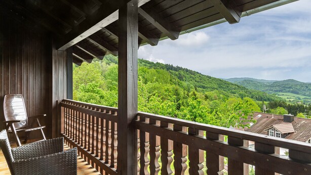 A wooden balcony with a view of green hills. - Apartment "Rachel" with Mountain View, Shared Terrace and Wi-Fi (Perlesreut)