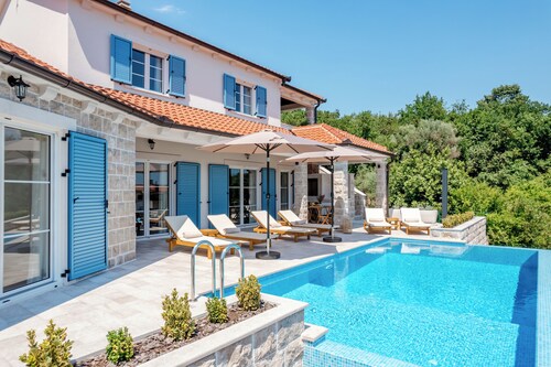 Spacious 4-bedroom villa with private heated pool, spa zone, and gym.