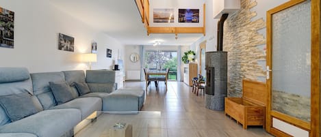 A modern living room with a sofa, coffee table, and a fireplace.
