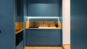 A compact kitchen with a built-in microwave, a sink, and a coffee maker. - Superior Family Apartment with Wi-Fi and Air Conditioning (Napoli)