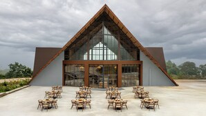 A modern building with a triangular roof and large glass windows.