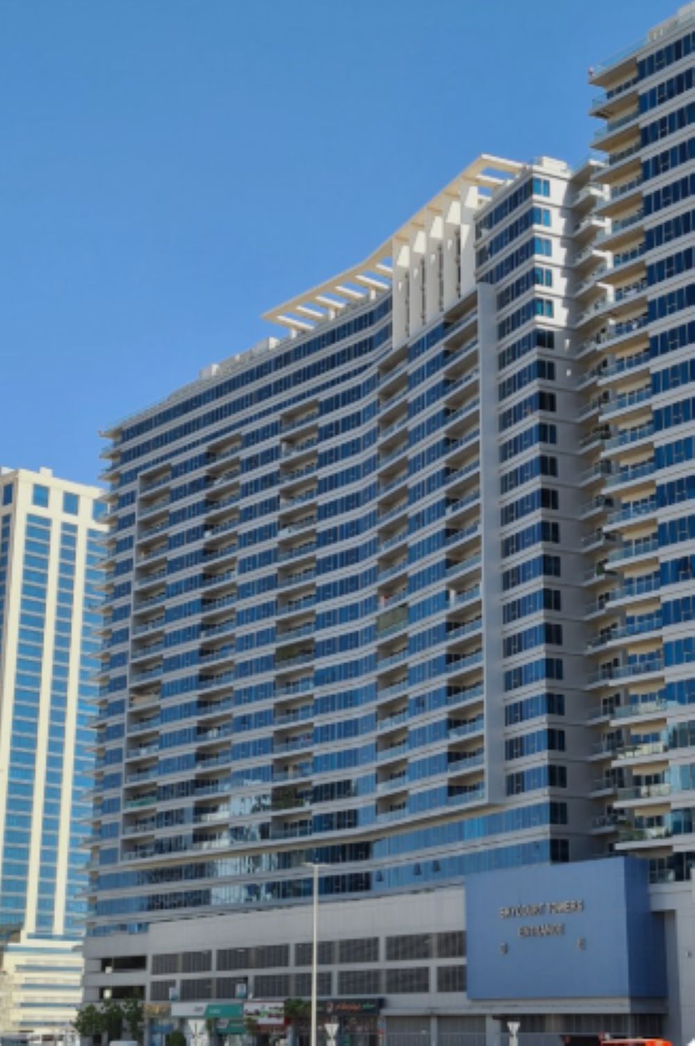 A high-rise hotel with multiple balconies and a prominent signage for "ZAYTANI HOTEL."