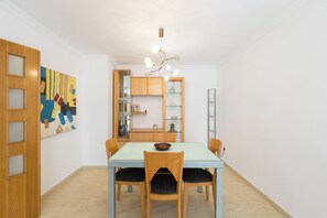 A dining area with a light blue table, wooden chairs, and a chandelier. - Javea Puerto I (Jávea)