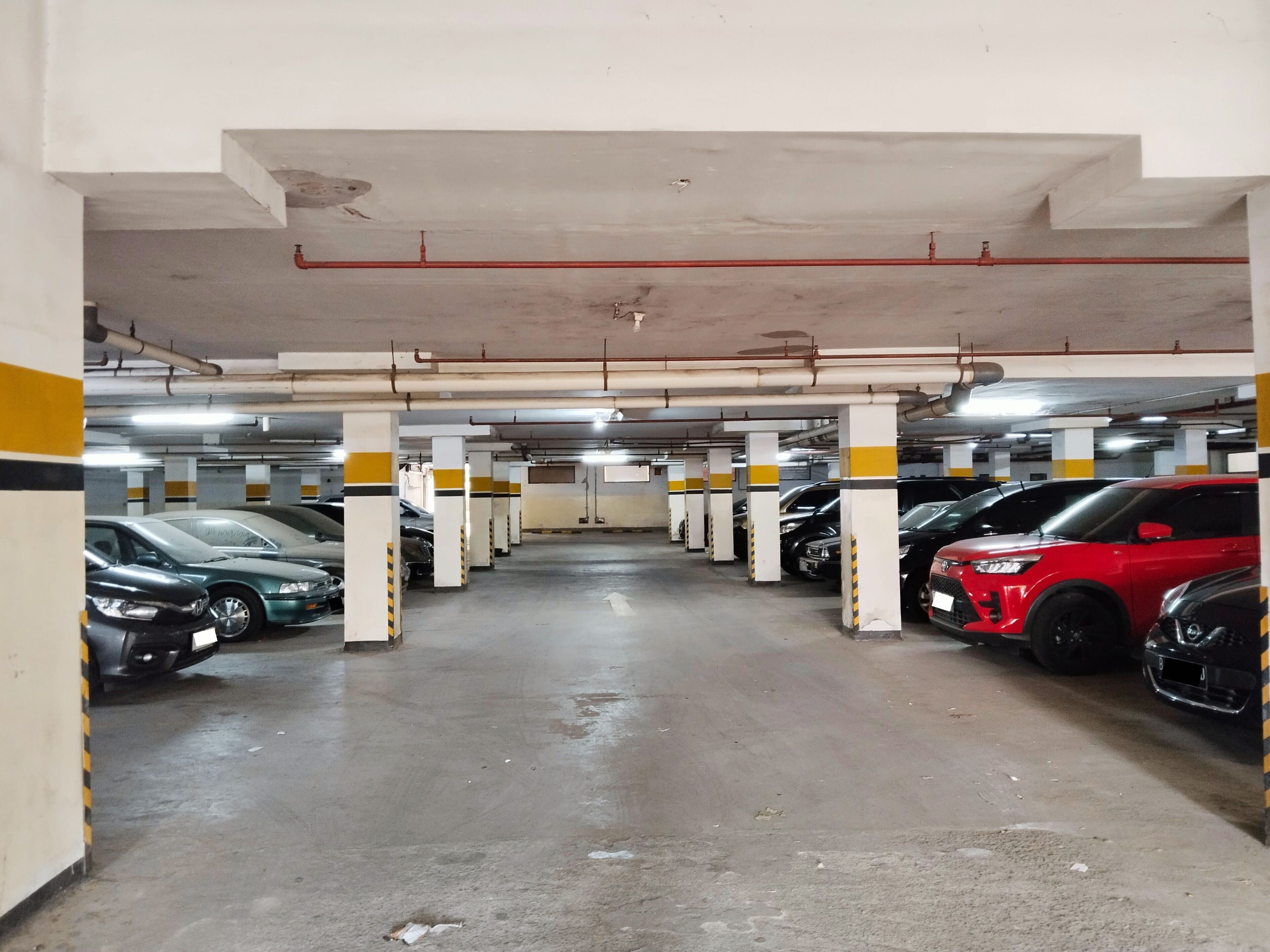 A multi-level parking garage with several cars parked.