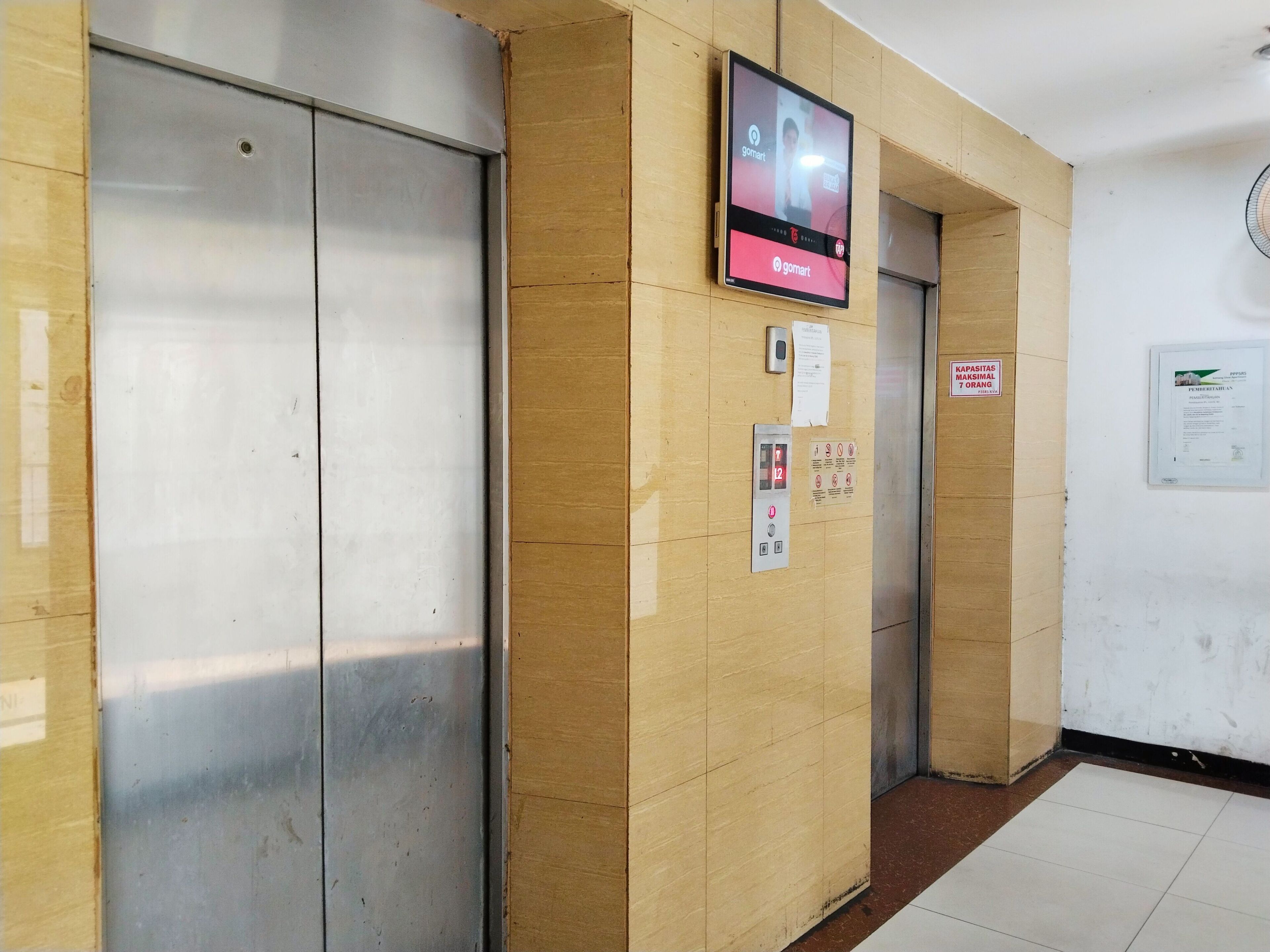 An elevator with a digital display and a control panel.
