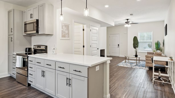 A modern kitchen with white cabinetry, stainless steel appliances, and pendant lighting. - Alto O4 I Modern New Construction 2Bd Apartment (Clarksville)