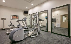 A fitness center with treadmills, elliptical machines, and a stationary bike. - Standard 2 Queen Room w/ Fridge | Pool. Gym. Wi-Fi (Dallas)