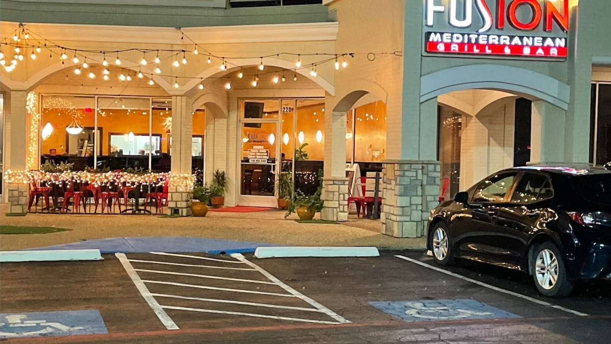 A Mediterranean-themed restaurant named Fusion with outdoor seating and string lights.