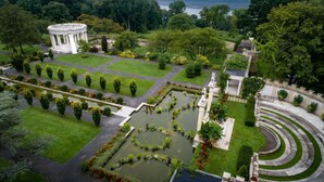 A formal garden with a circular pavilion, a central pond, and a terraced area. - Near Ridge Hill shopping. Breakfast. Pool. Bar. (Yonkers)