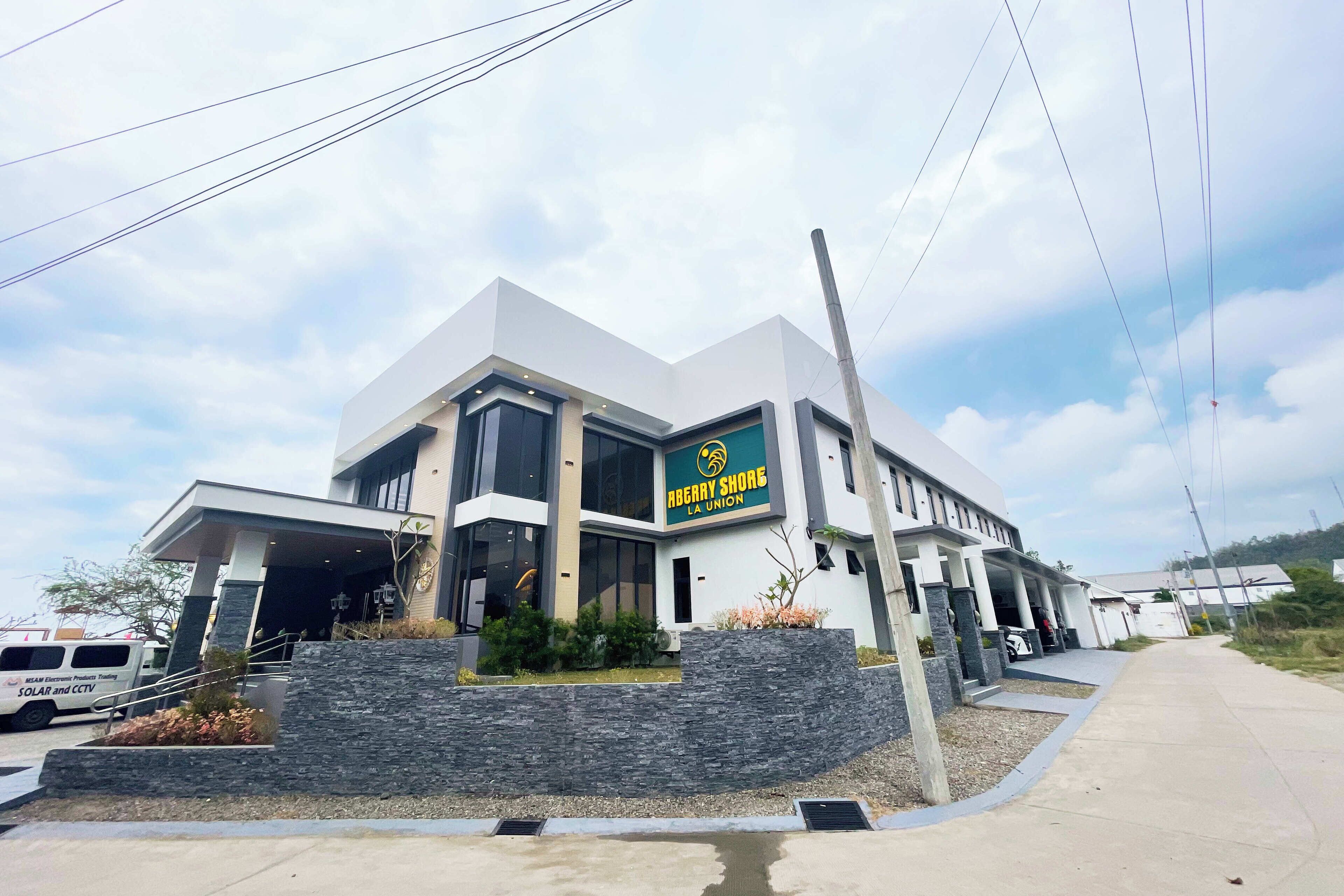 A modern building with a sign reading "Berry Shore LA Union".