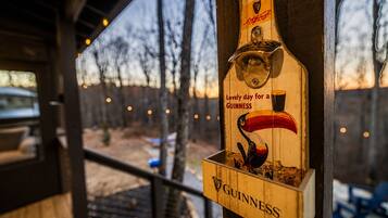 A wooden beer tap with a Guinness logo and a swan illustration, attached to a wooden post.