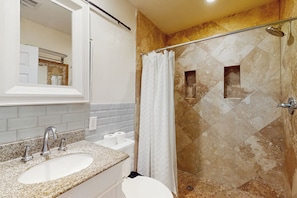 A bathroom with a granite countertop sink, a mirror, a shower with a glass door, and a tiled wall. - 4 Mi to Dtwn: Pet-friendly Getaway in Phoenix (Phoenix)