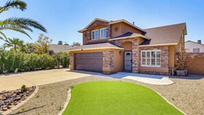 A two-story house with a garage, a well-maintained lawn, and a clear blue sky. - 4BR Home w/ Private Pool, Patio & Grill (Glendale)