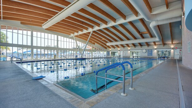 An indoor swimming pool with a wooden ceiling and large windows. - Resort Amenities, 7 Mi to Dtwn: Sarasota Home! (Sarasota)