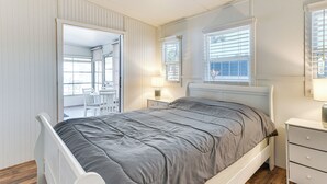 A bedroom with a bed, bedside table, lamp, and a view of an outdoor area. - Resort Amenities, 7 Mi to Dtwn: Sarasota Home! (Sarasota)