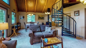 A spacious living room with a wooden ceiling, a staircase, and a dining area. - Deck & Mtn Views! Family A-frame Cabin Near Stream (Bailey)