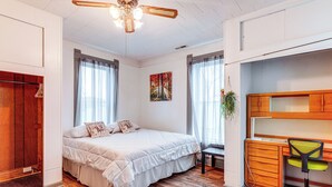 A bedroom with a bed, a desk, and a chair. - Wine, Dine & Unwind: Hermann Home w/ Spacious Yard (Hermann)