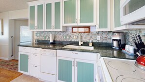 A kitchen with white cabinets, a tiled backsplash, and a microwave. - Manufactured w/ Pools, Hot Tubs, Pickleball, AC (Surprise)